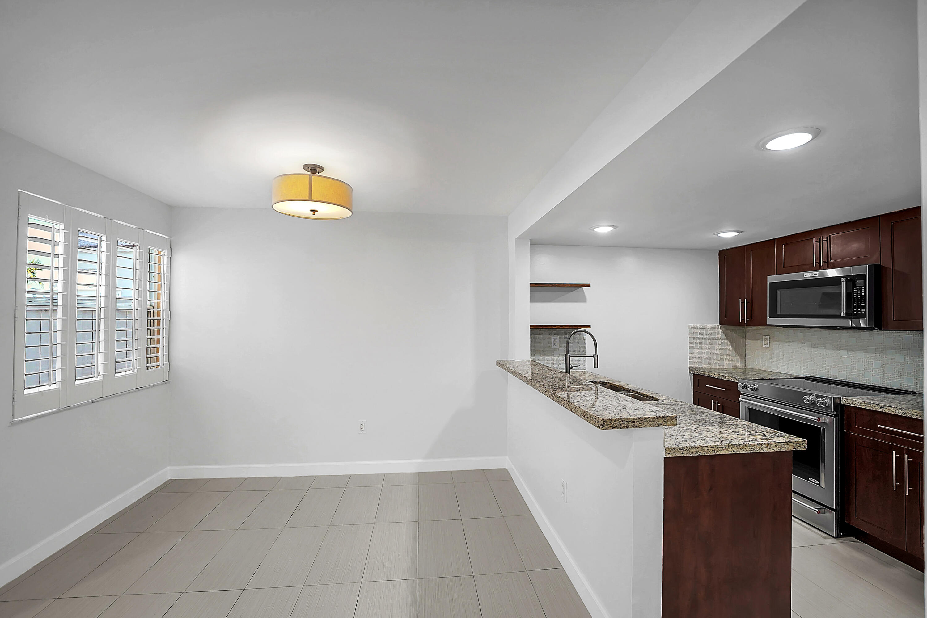 4550 Southwest 68th Ct Circle, Unit 548 Miami, FL 33155 - Photo 38 of 51 a kitchen with stainless steel appliances granite countertop a sink and a microwave