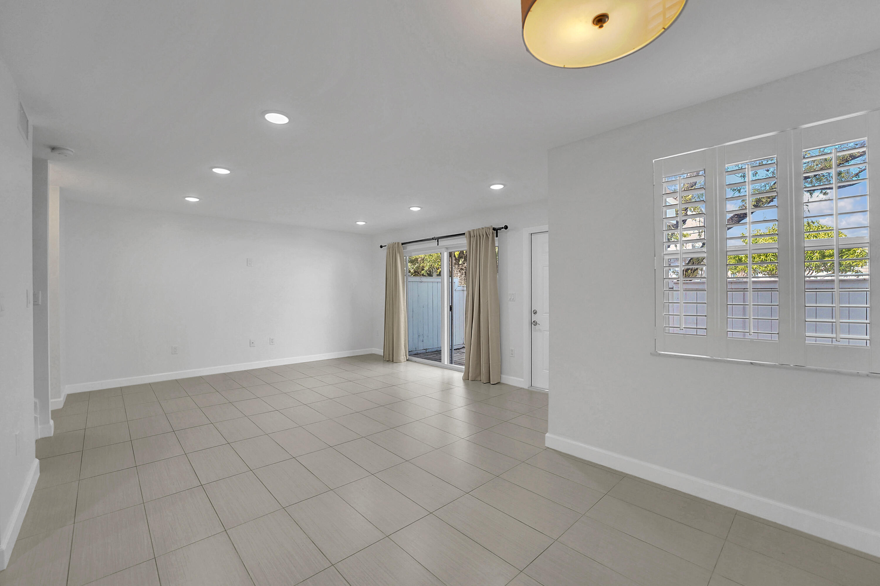4550 Southwest 68th Ct Circle, Unit 548 Miami, FL 33155 - Photo 40 of 51 an empty room with windows and entrance