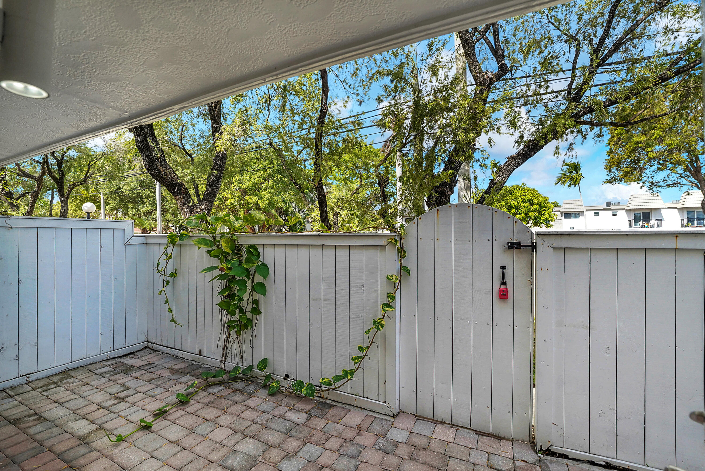 4550 Southwest 68th Ct Circle, Unit 548 Miami, FL 33155 - Photo 45 of 51 a wooden fence with trees in front of it