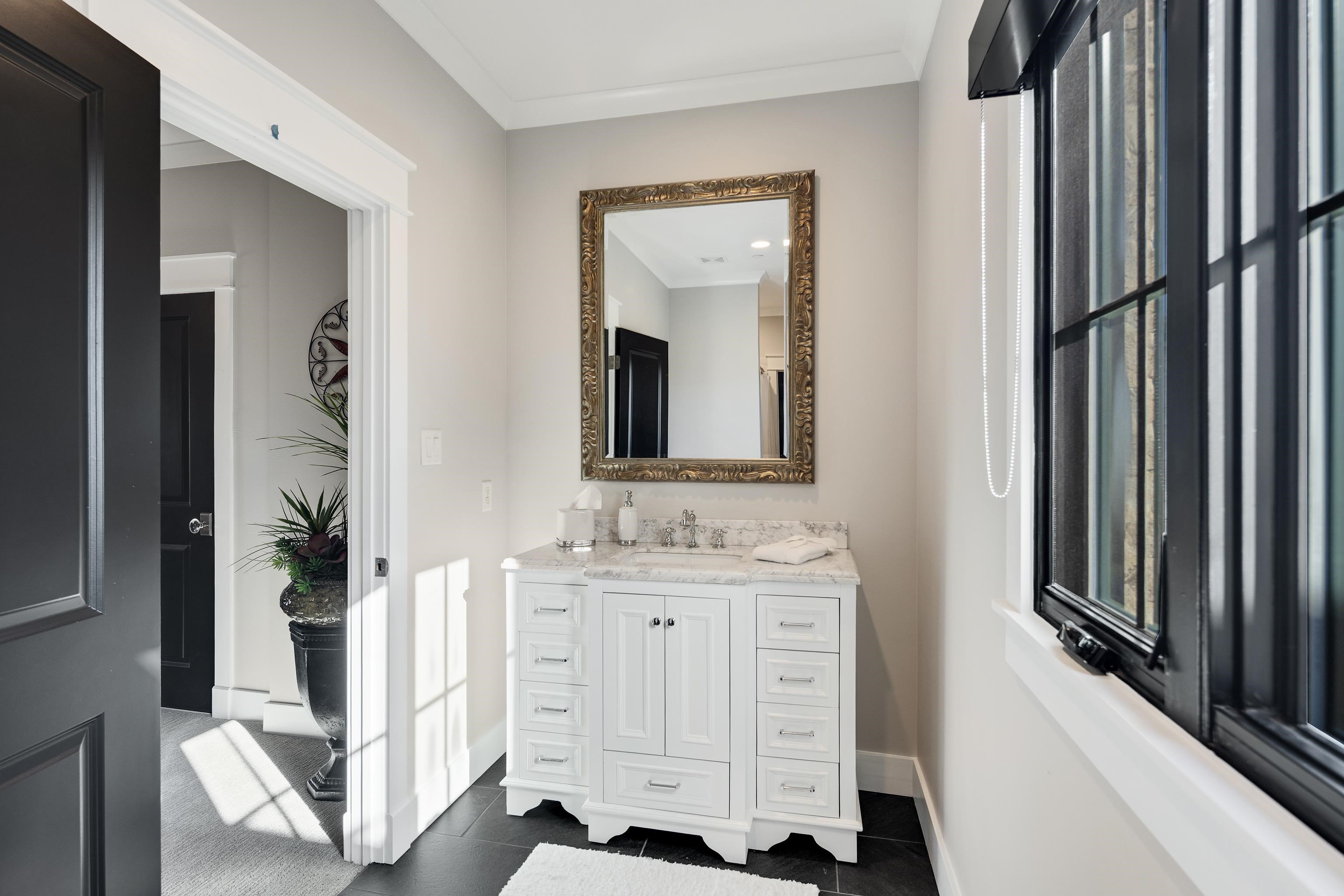 170 Twin Lakes Road Piperton, TN 38017 - Photo 16 of 40 Bathroom with vanity, dark tile patterned floors, and crown molding