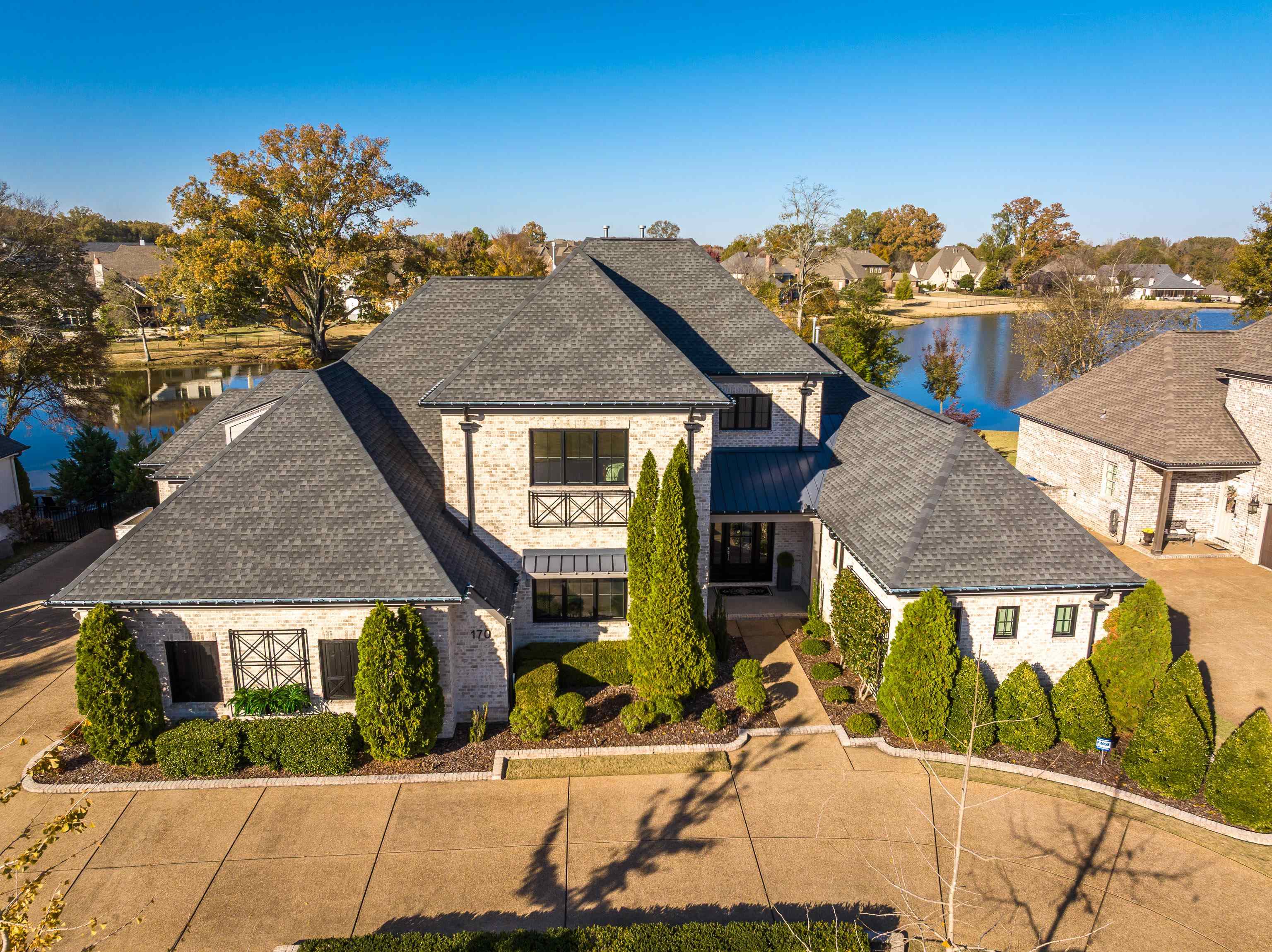 170 Twin Lakes Road Piperton, TN 38017 - Photo 22 of 40 View of front of house with a shingled roof, a water view, and stone siding