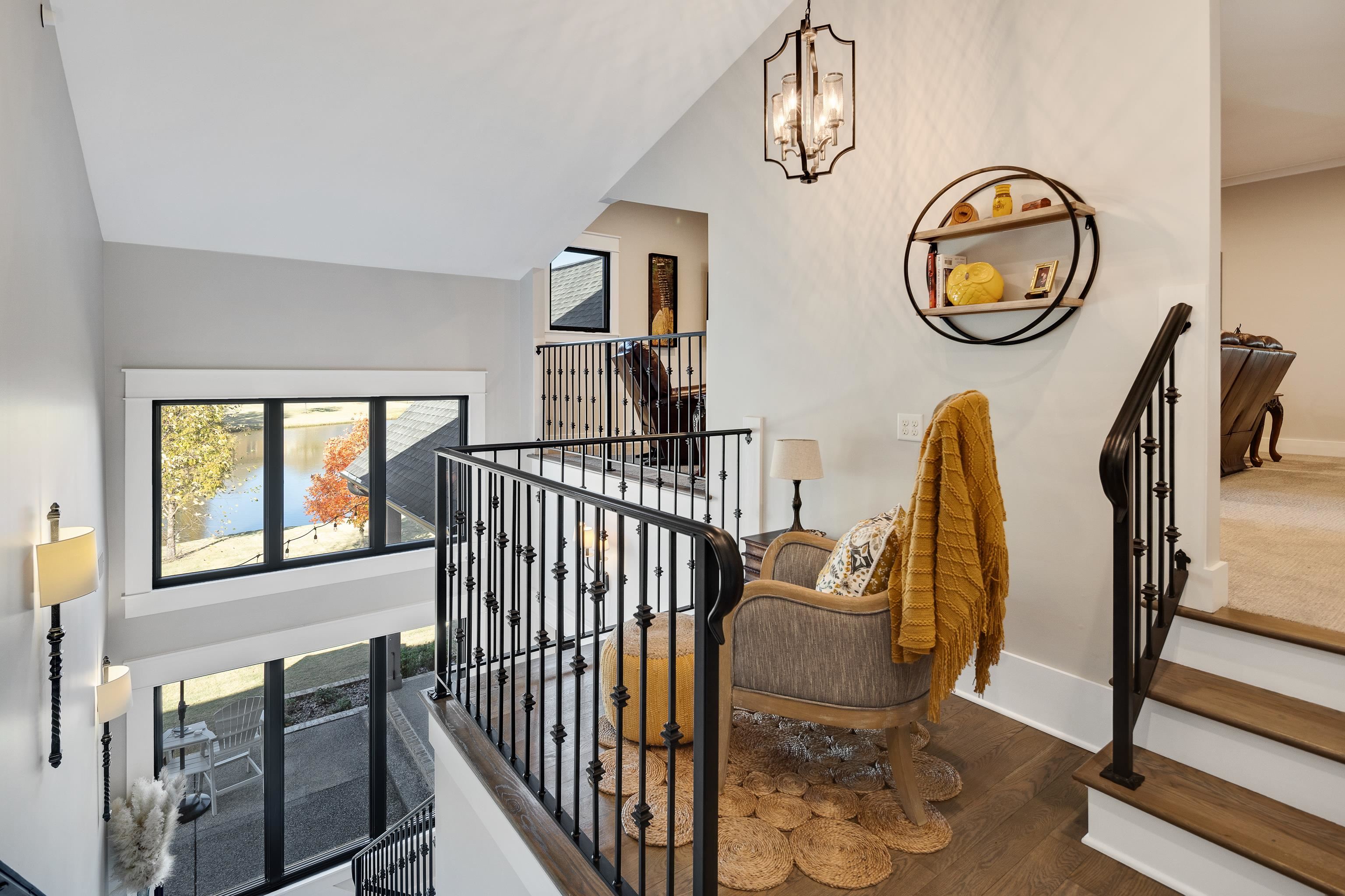170 Twin Lakes Road Piperton, TN 38017 - Photo 34 of 40 Stairway featuring hardwood / wood-style flooring and a chandelier