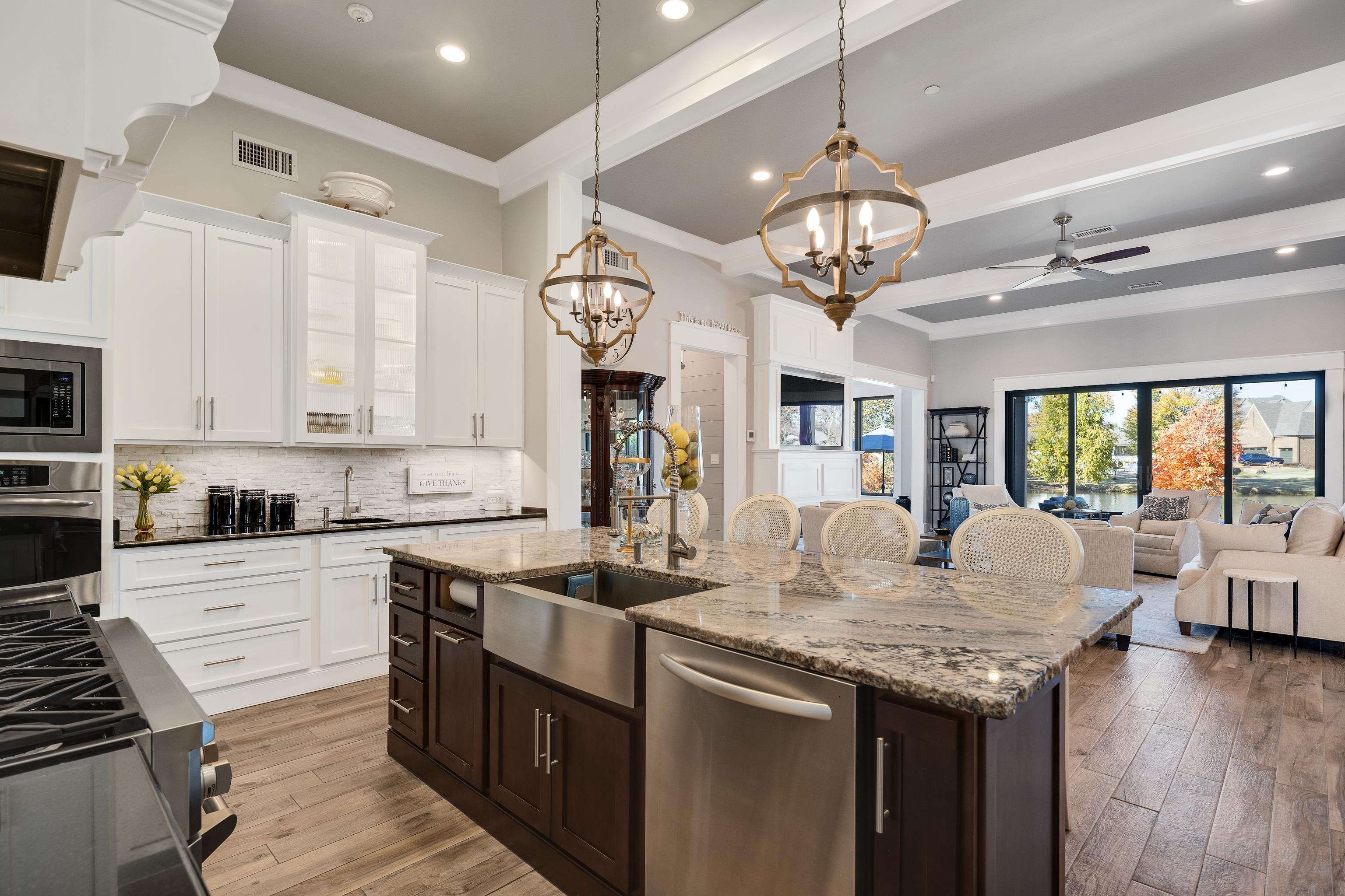 170 Twin Lakes Road Piperton, TN 38017 - Photo 40 of 40 Kitchen featuring dark brown cabinetry, a breakfast bar area, open floor plan, dark stone counters, and recessed lighting