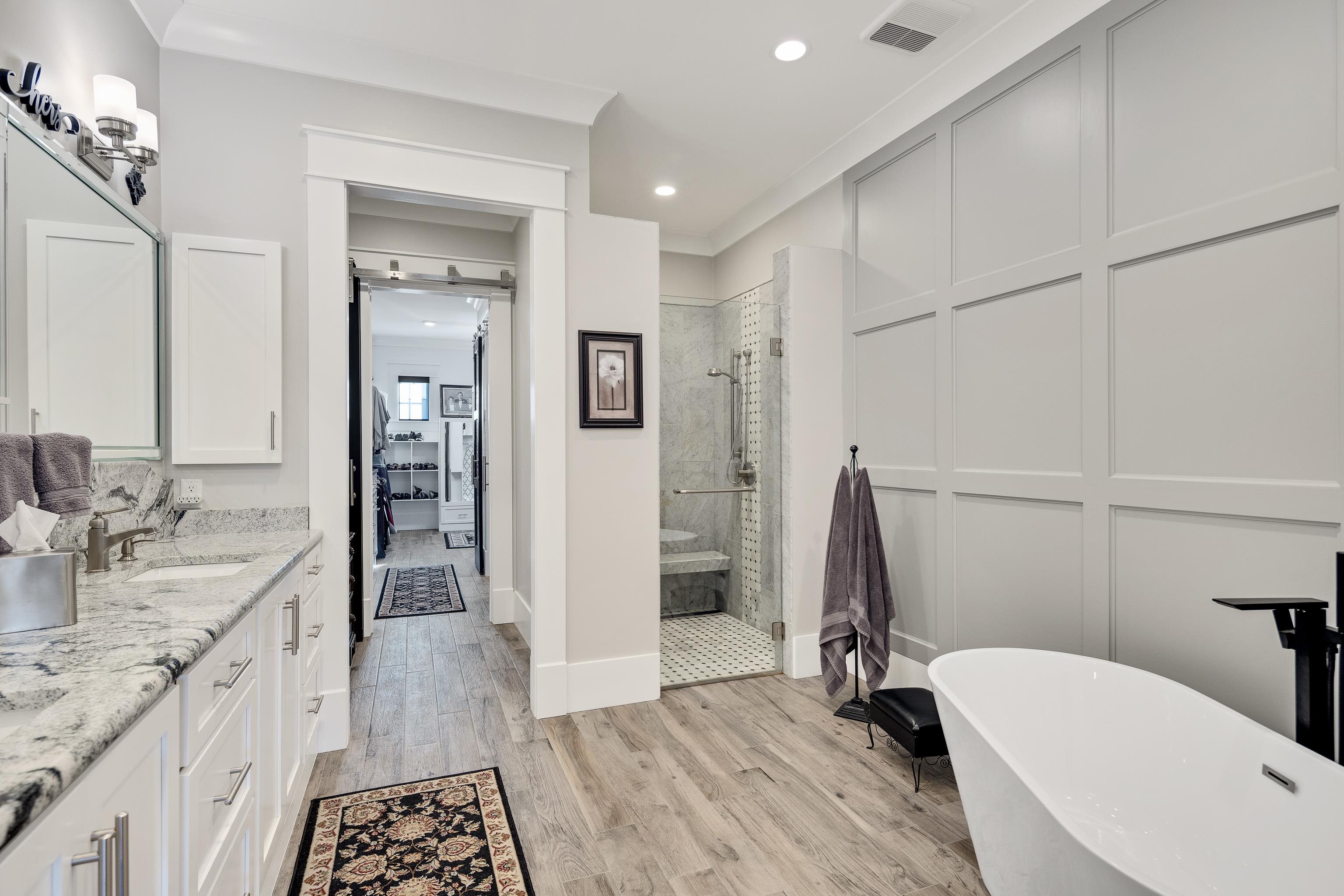 170 Twin Lakes Road Piperton, TN 38017 - Photo 9 of 40 Bathroom featuring double vanity, light wood-style floors, a freestanding bath, a shower stall, and recessed lighting