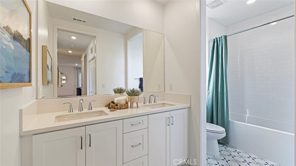 532 Neilson Irvine, CA 92618 - Photo 14 of 28 a bathroom with a double vanity sink toilet and shower