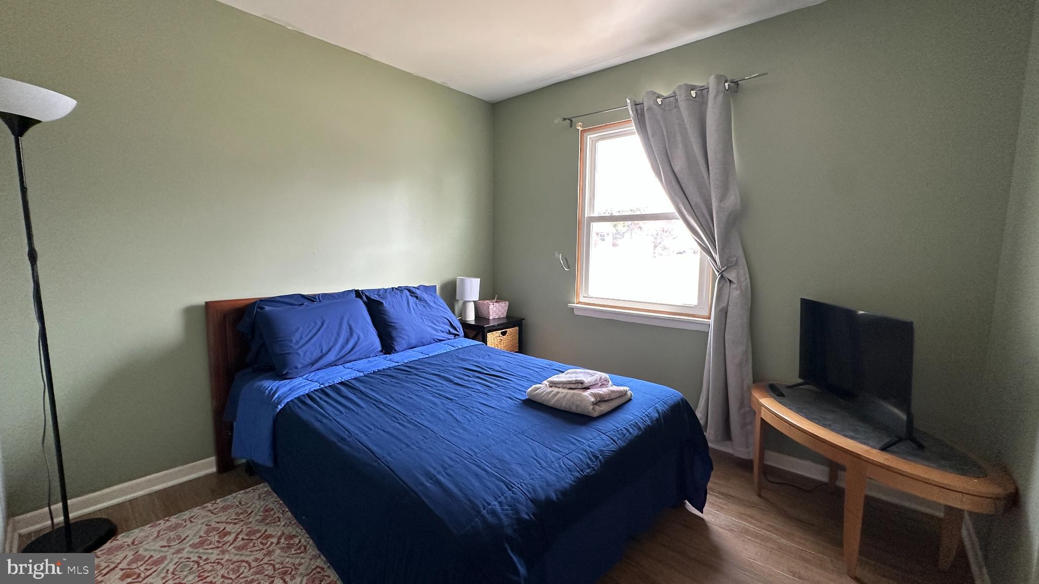 228 Embleton Road Owings Mills, MD 21117 - Photo 16 of 31 Serene green bedroom with cozy ambiance.