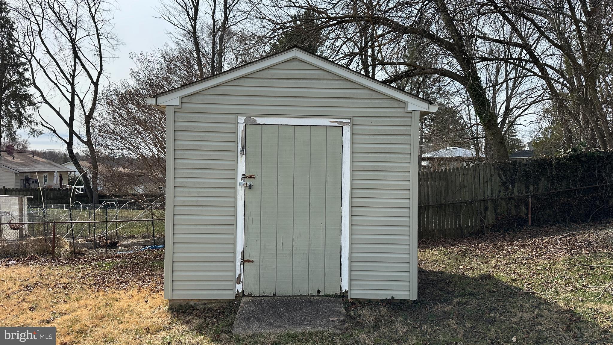 228 Embleton Road Owings Mills, MD 21117 - Photo 31 of 31 Charming garden shed in serene backyard setting.