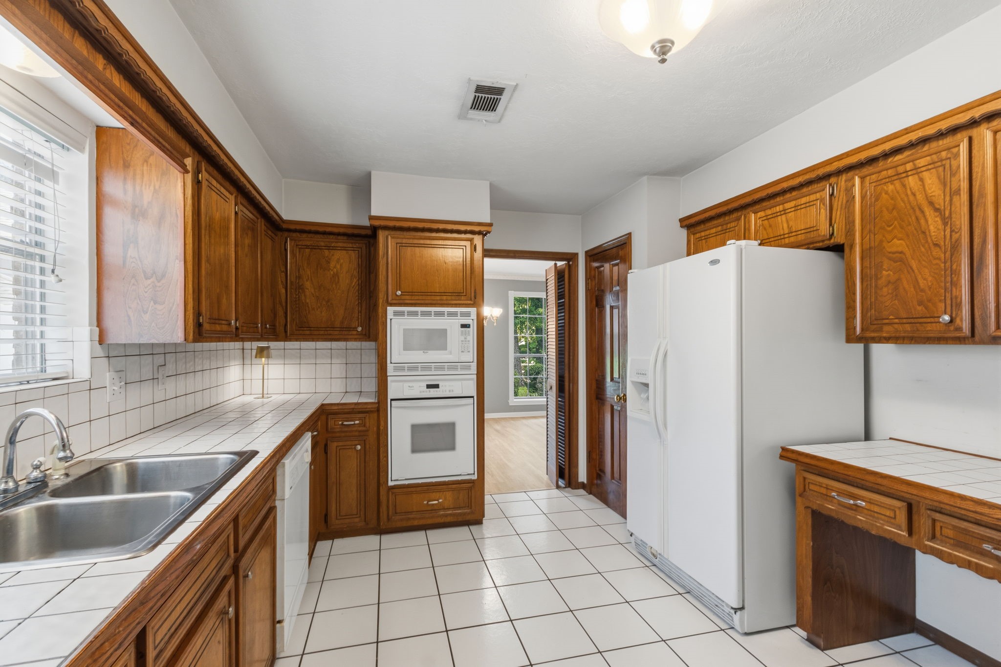 3422 Candlewisp Drive Spring, TX 77388 - Photo 13 of 50 KITCHEN - Opens to the formal dining room with louvered doors separating the two rooms. Walk-in pantry on the other side of the refrigerator. Refrigerator to remain.