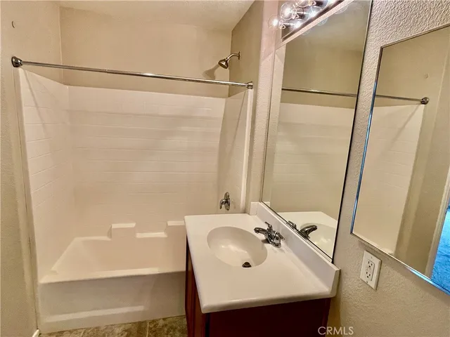 a bathroom with a sink a mirror and a shower
