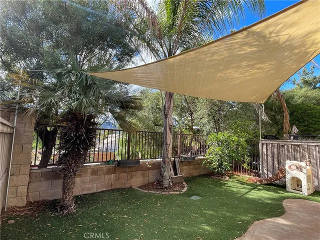 a view of a chair and table in backyard of the house