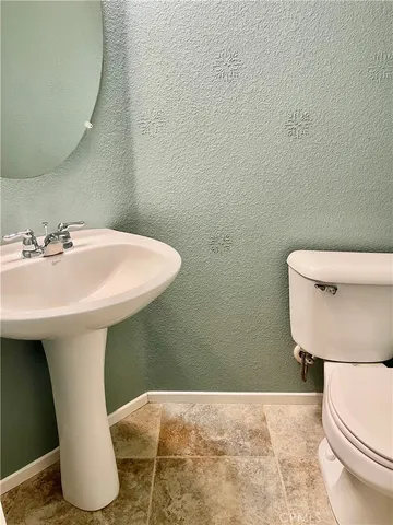 a bathroom with a sink toilet and mirror