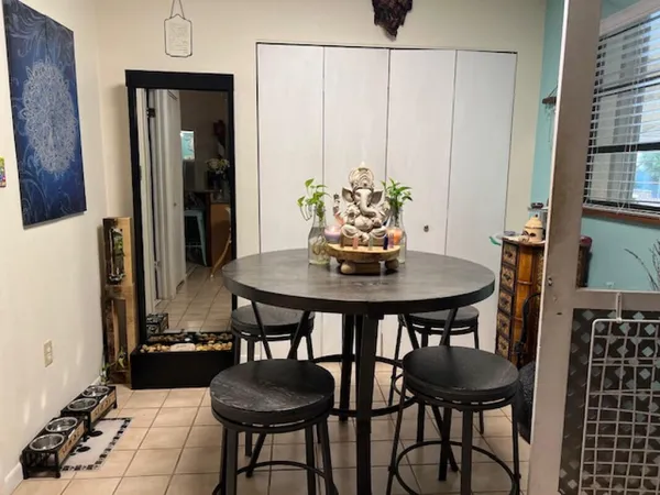 a view of a dining room with furniture and window