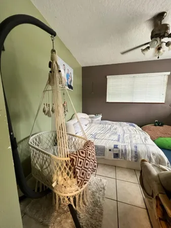 a bed sitting in a bedroom next to a window