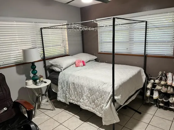 a bedroom with a bed and a window