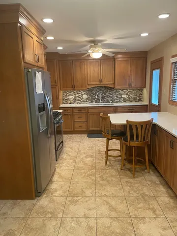 a large kitchen with a table and chairs