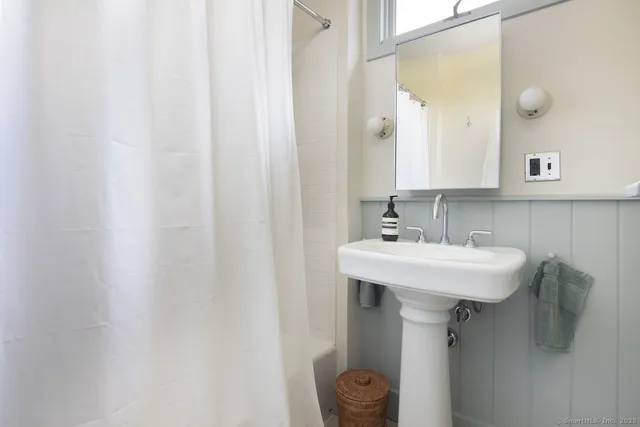 a bathroom with a sink a toilet and mirror