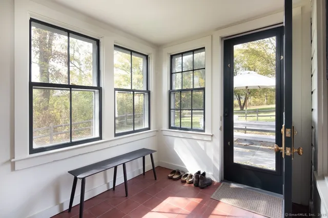 a living room filled with furniture and a window