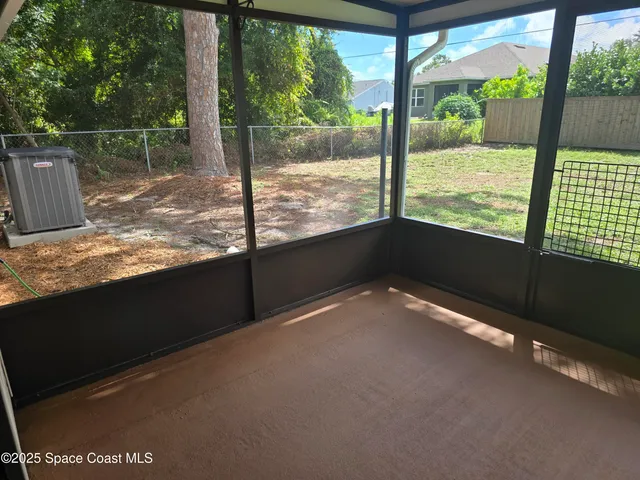 a view of a floor to ceiling window next to a yard