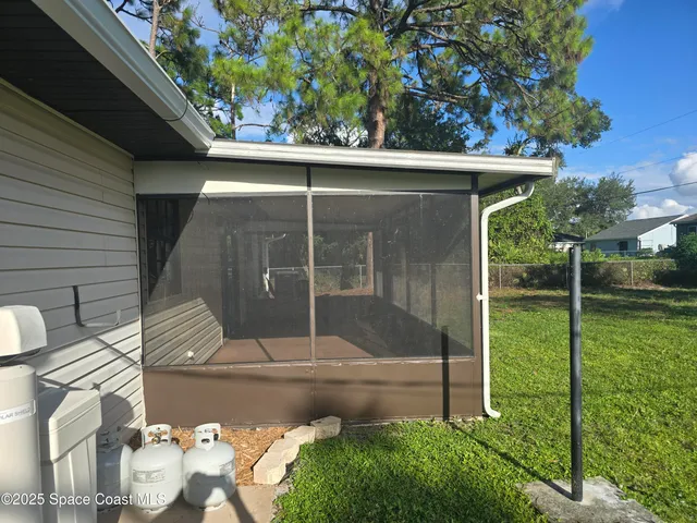 a view of backyard with small cabin