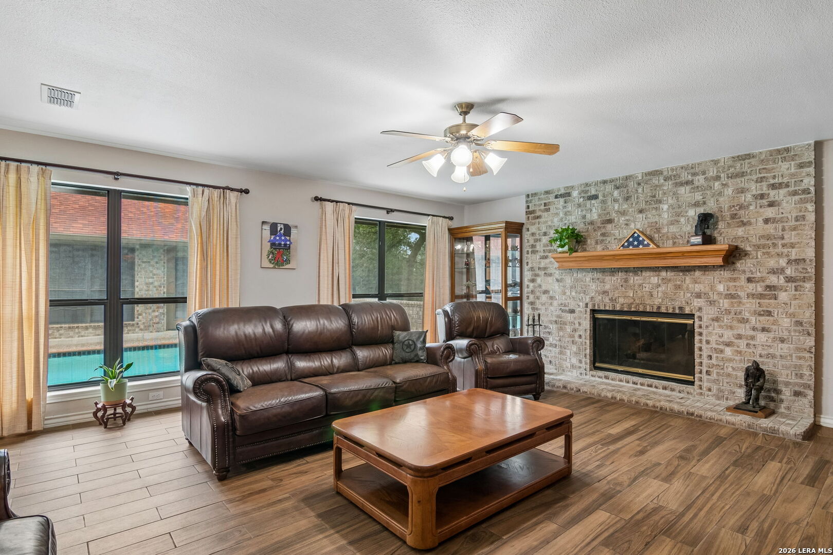 188 Guadalupe Ranch Lane Seguin, TX 78155 - Photo 32 of 56 a living room with furniture and a fireplace