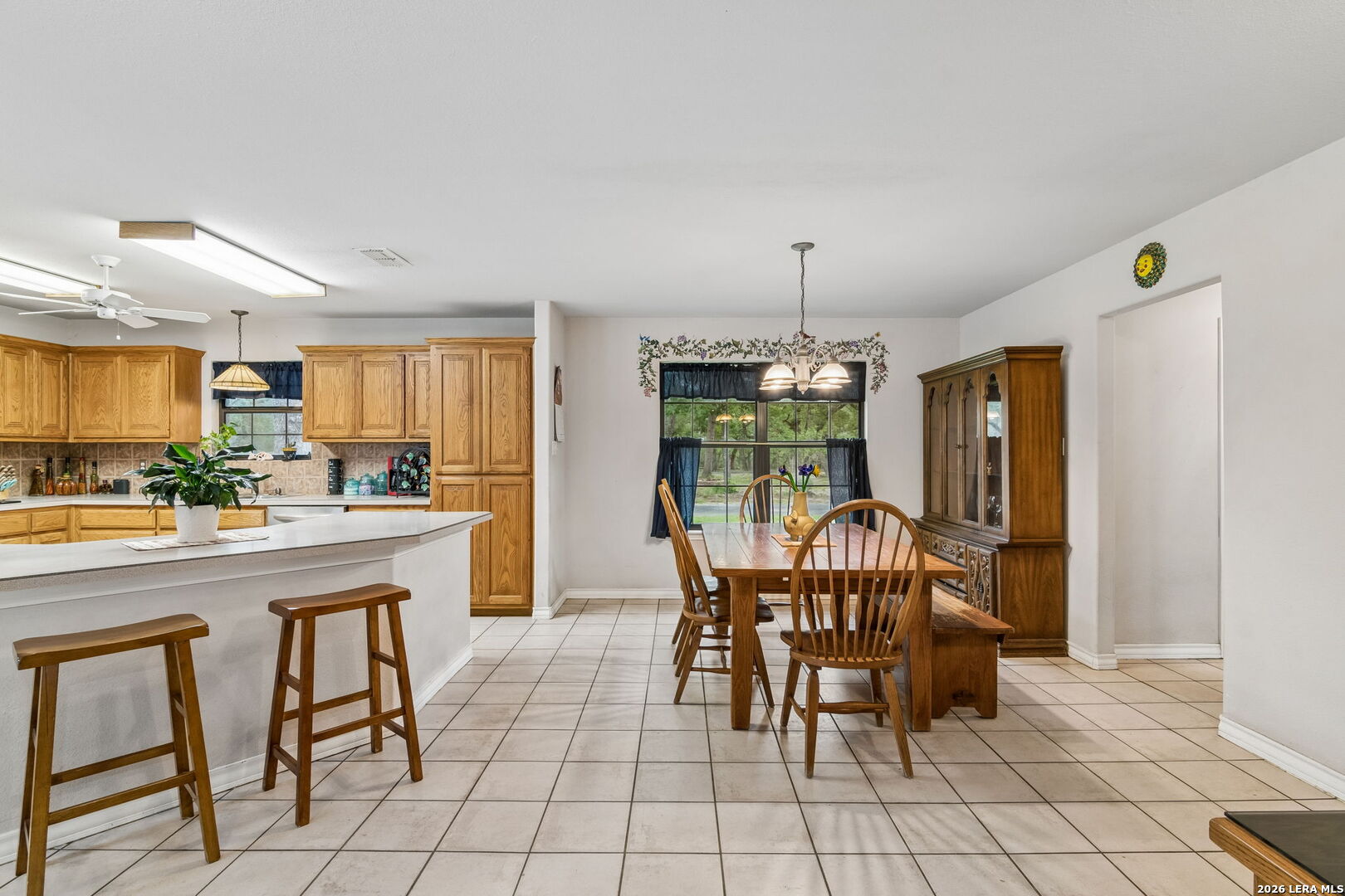188 Guadalupe Ranch Lane Seguin, TX 78155 - Photo 43 of 56 a dining room filled a chandelier and kitchen view