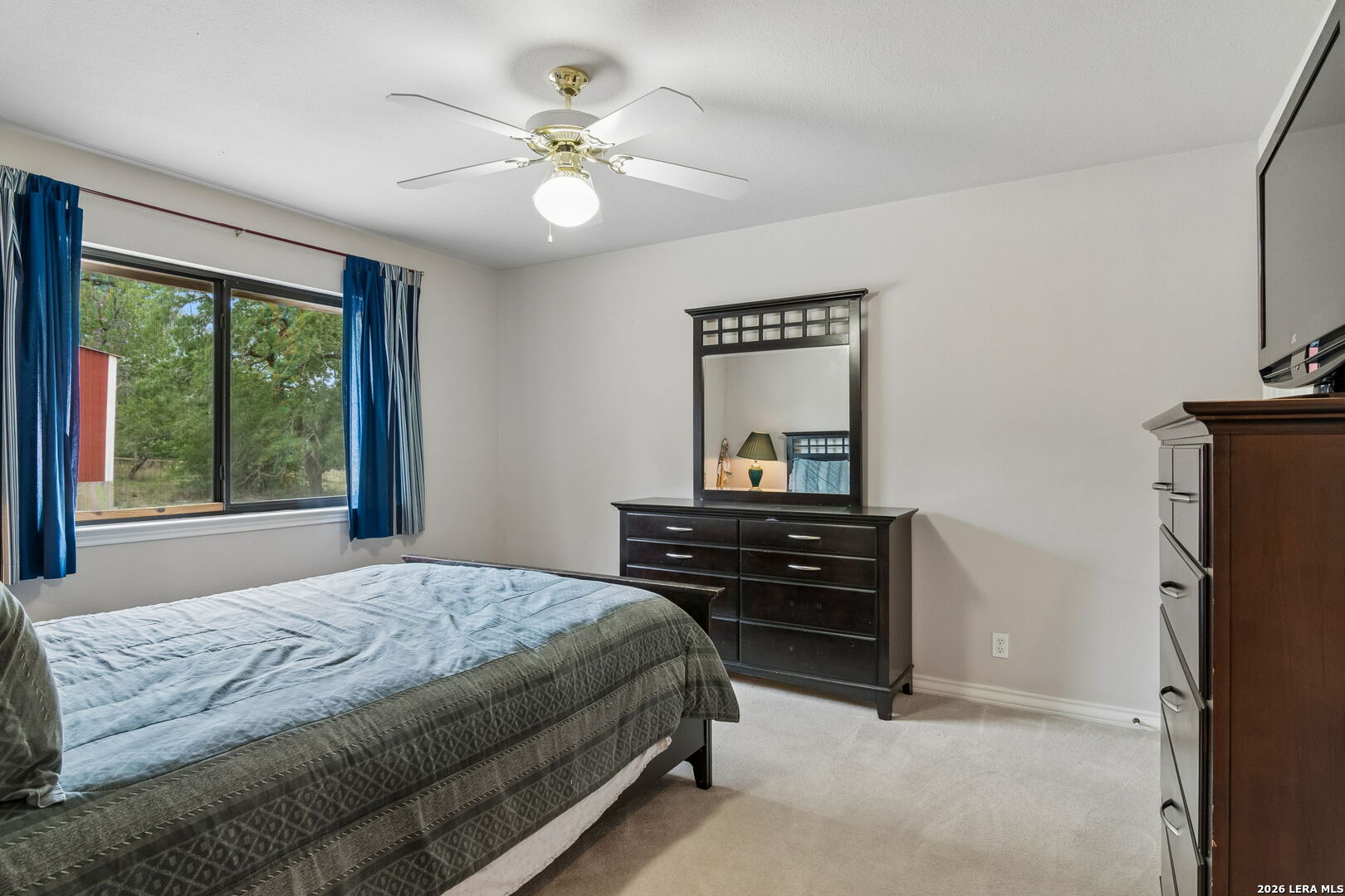 188 Guadalupe Ranch Lane Seguin, TX 78155 - Photo 48 of 56 a bedroom with a bed and a chandelier