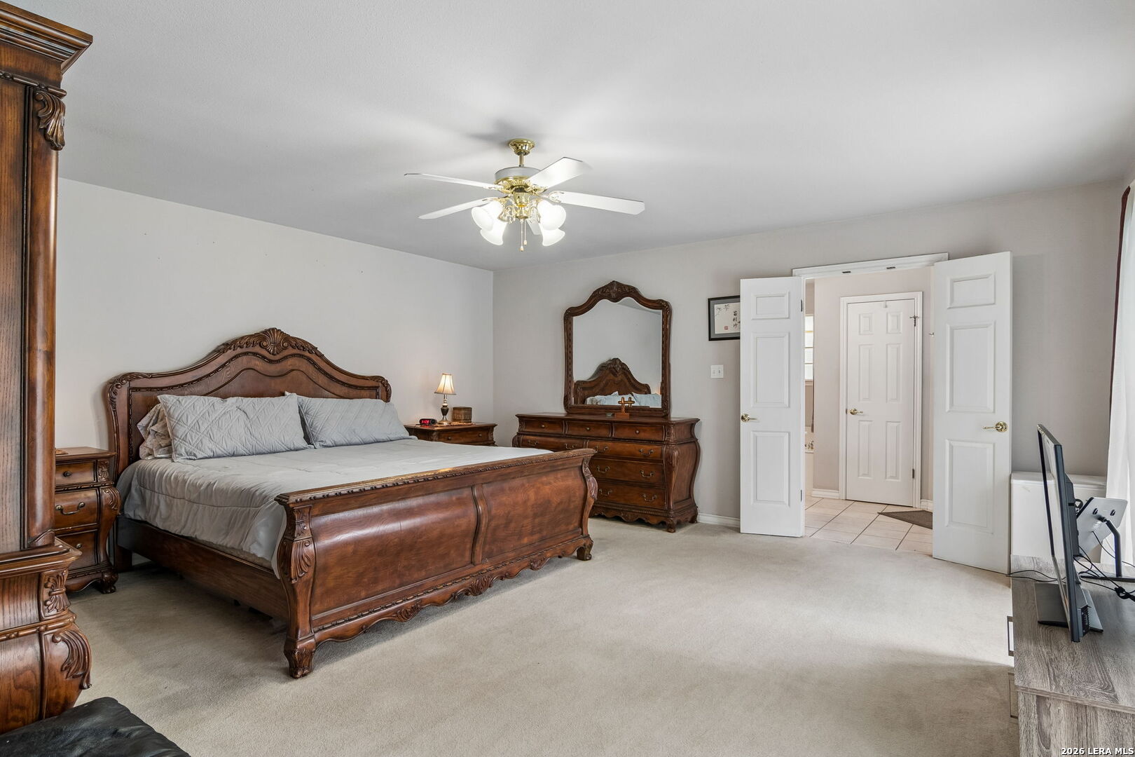 188 Guadalupe Ranch Lane Seguin, TX 78155 - Photo 52 of 56 a spacious bedroom with a bed and a chandelier