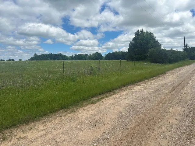 a view of a field with a big yard
