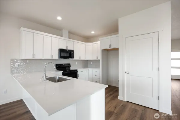 a kitchen with a sink and a stove top oven