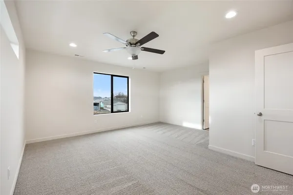 a view of an empty room with a ceiling fan