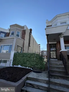 a front view of a house with plants