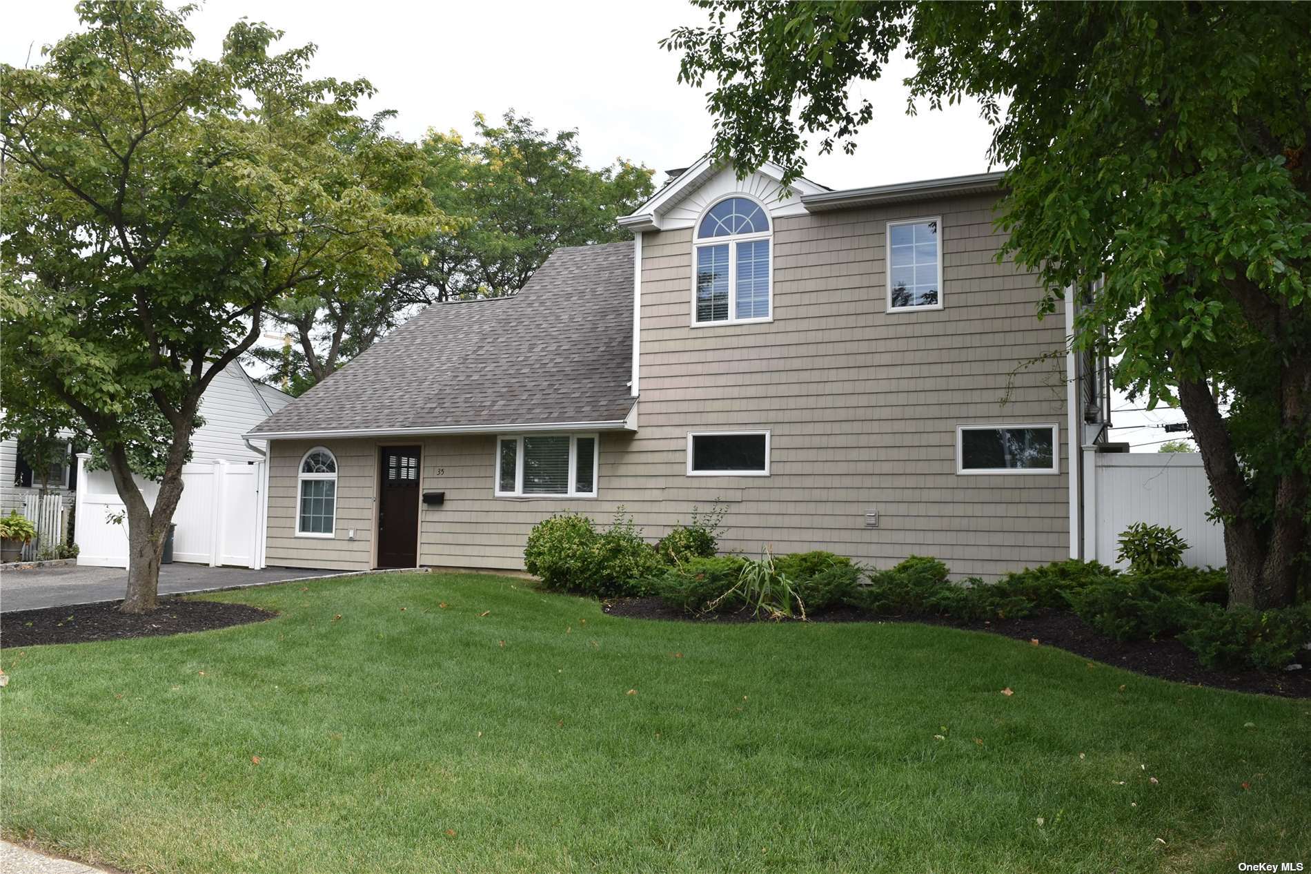35 Constellation Road Levittown, NY 11756 - Photo 1 of 1 a view of a house with a yard and a large tree