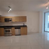 a kitchen with stainless steel appliances a stove a sink and a refrigerator