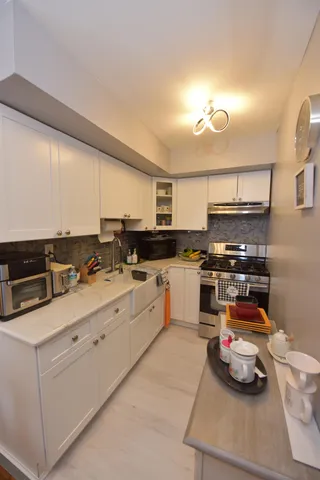 a kitchen with stainless steel appliances granite countertop a sink and cabinets