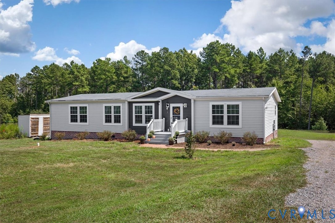 Single-story property featuring light gray siding