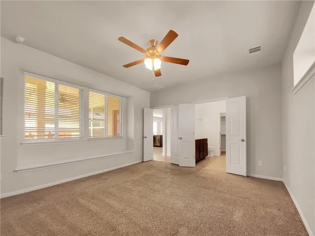 a view of a livingroom with a ceiling fan and window
