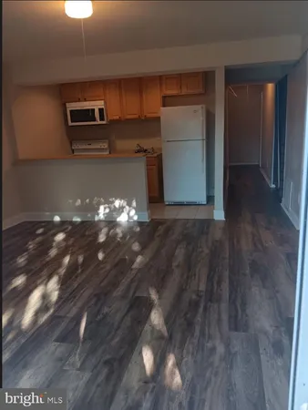 a white refrigerator freezer sitting inside of a kitchen