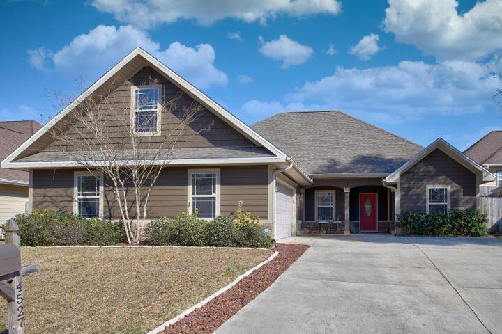 4527 Hermosa Road Crestview, FL 32539 - Photo 1 of 1 a front view of a house with yard