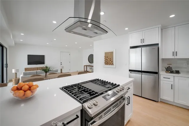 a kitchen with stainless steel appliances a stove a sink and a refrigerator