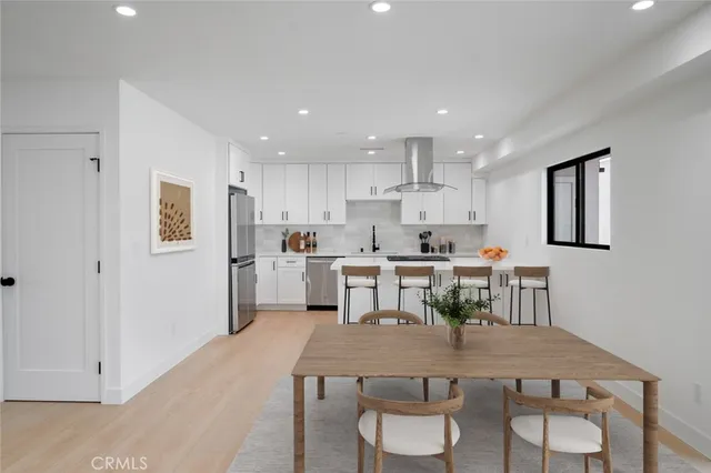 a large kitchen with a table and chairs