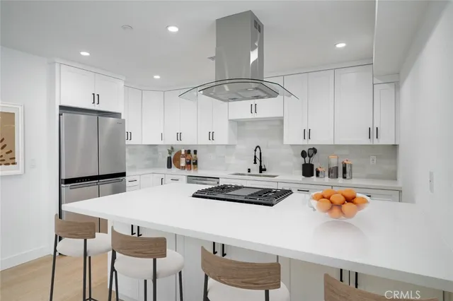 a kitchen with stainless steel appliances stove refrigerator sink and cabinets