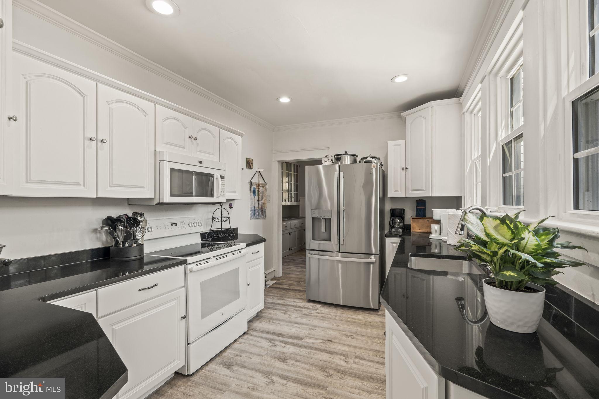 4161 Orchard Lane Philadelphia, PA 19154 - Photo 23 of 42 a kitchen with stainless steel appliances white cabinets and a refrigerator