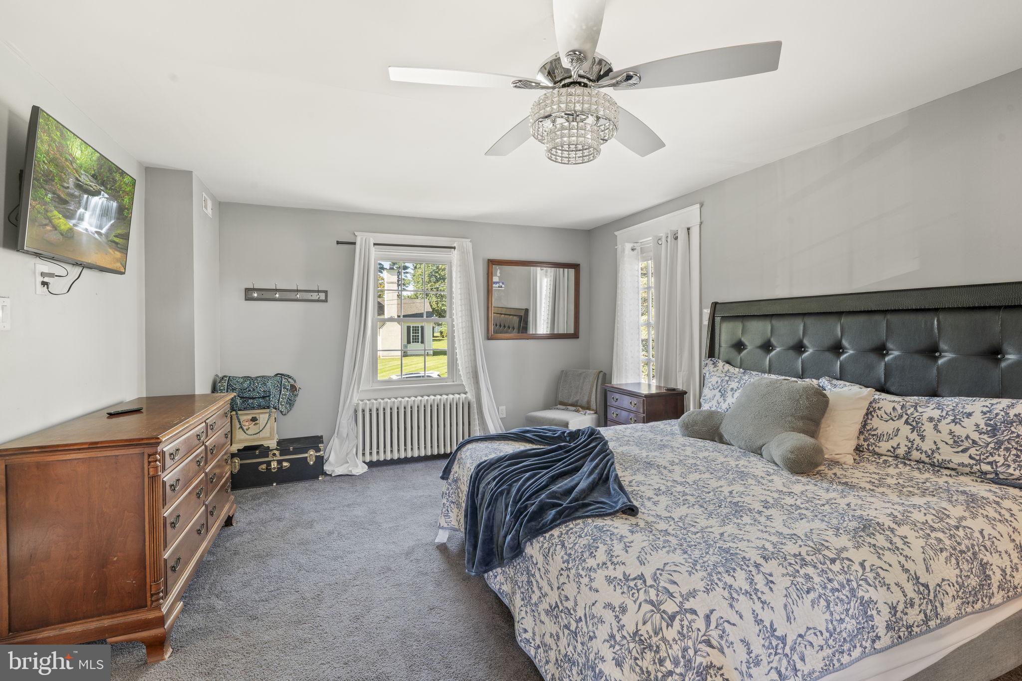 4161 Orchard Lane Philadelphia, PA 19154 - Photo 27 of 42 a bedroom with a bed a chandelier furniture and a window