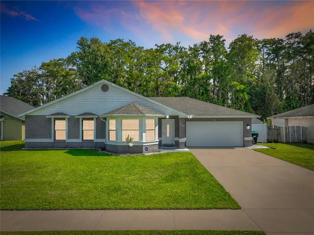 a front view of a house with a yard and garage