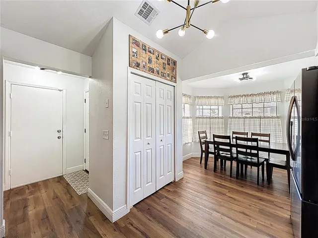 a view of a dining room with furniture and wooden floor