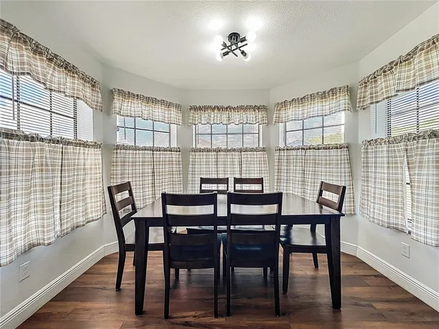 a view of a dining room with furniture and wooden floor