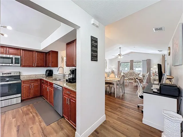 a large kitchen with stainless steel appliances granite countertop a large center island and a sink