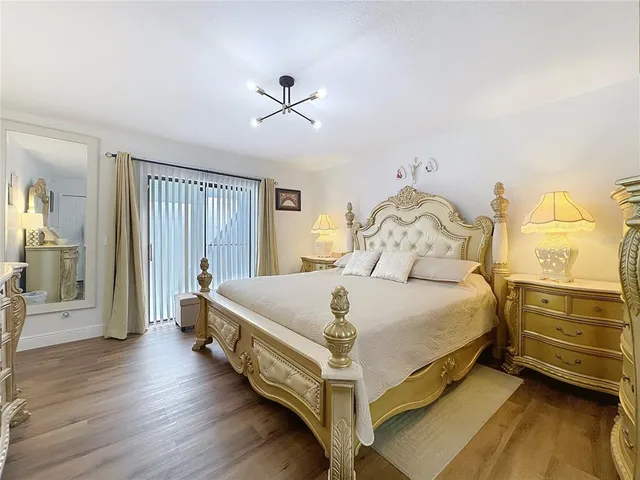 a bedroom with a bed and a chandelier