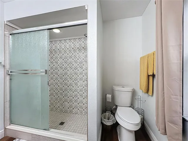 a bathroom with a shower and a toilet