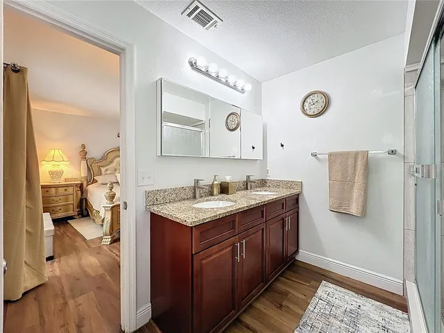 a spacious bathroom with a sink vanity and a mirror